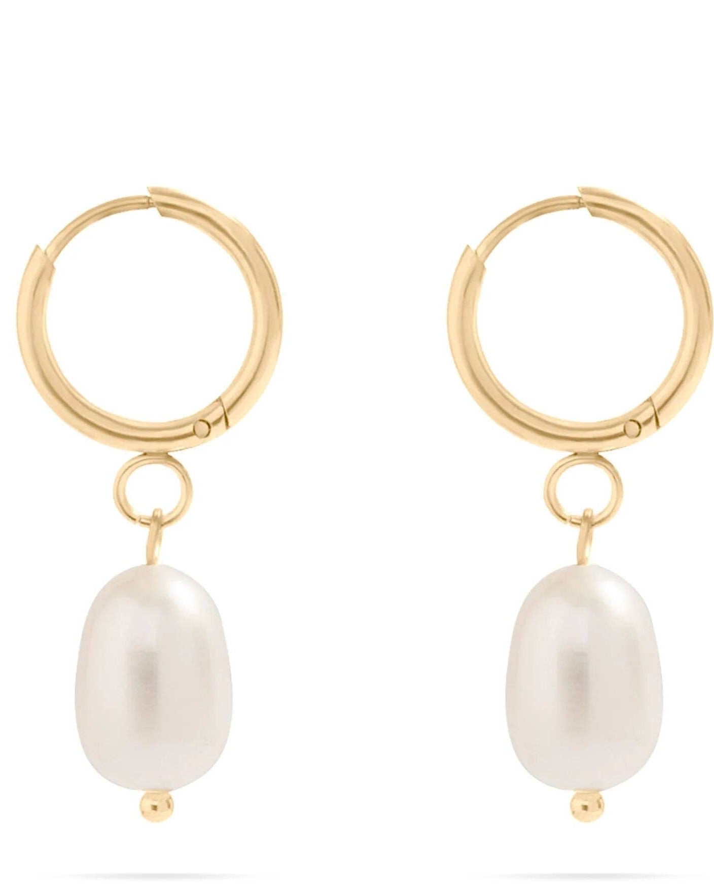 Gold hoop earrings with pearl drops on a white background