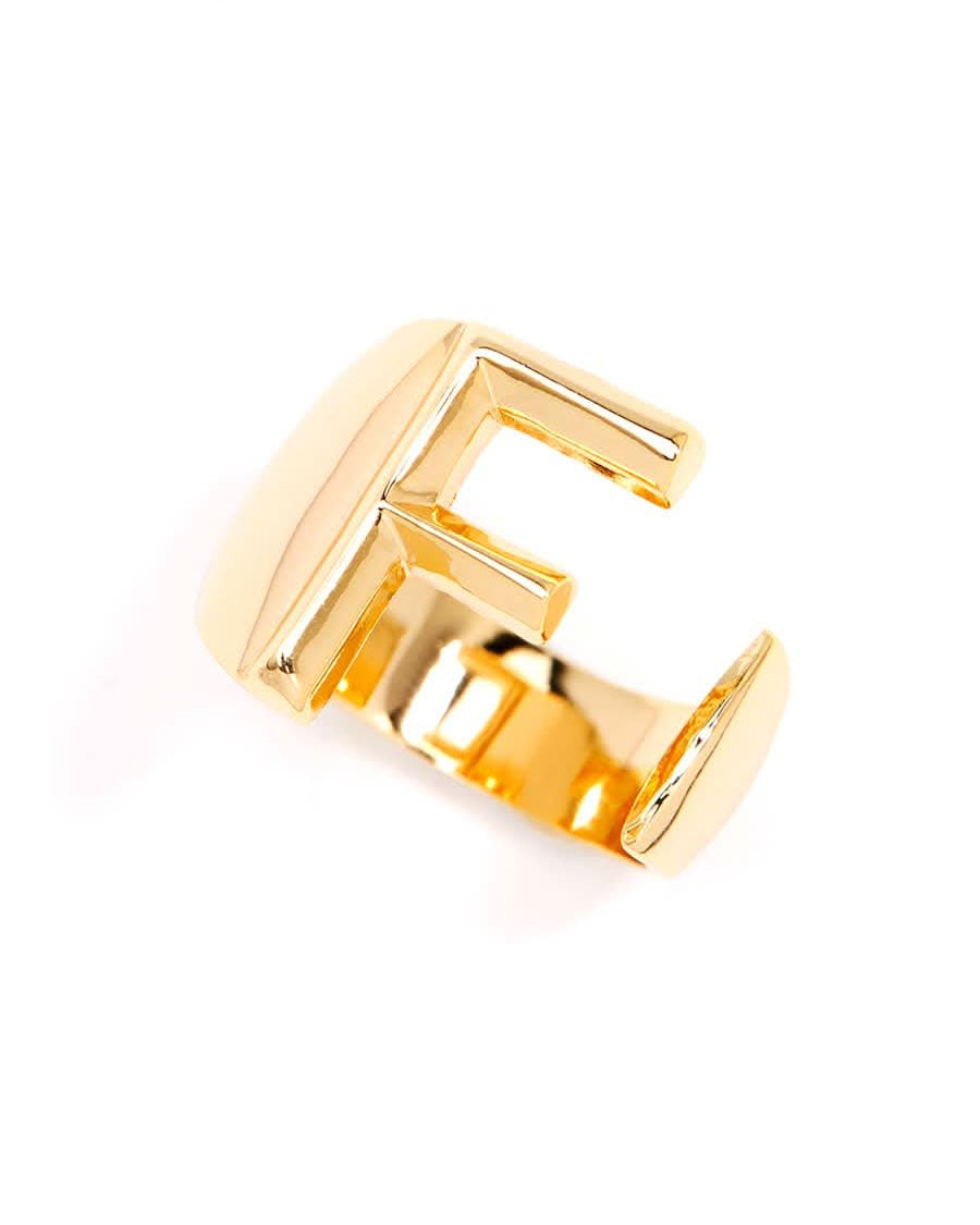 Gold adjustable letter ring on white background in letter F