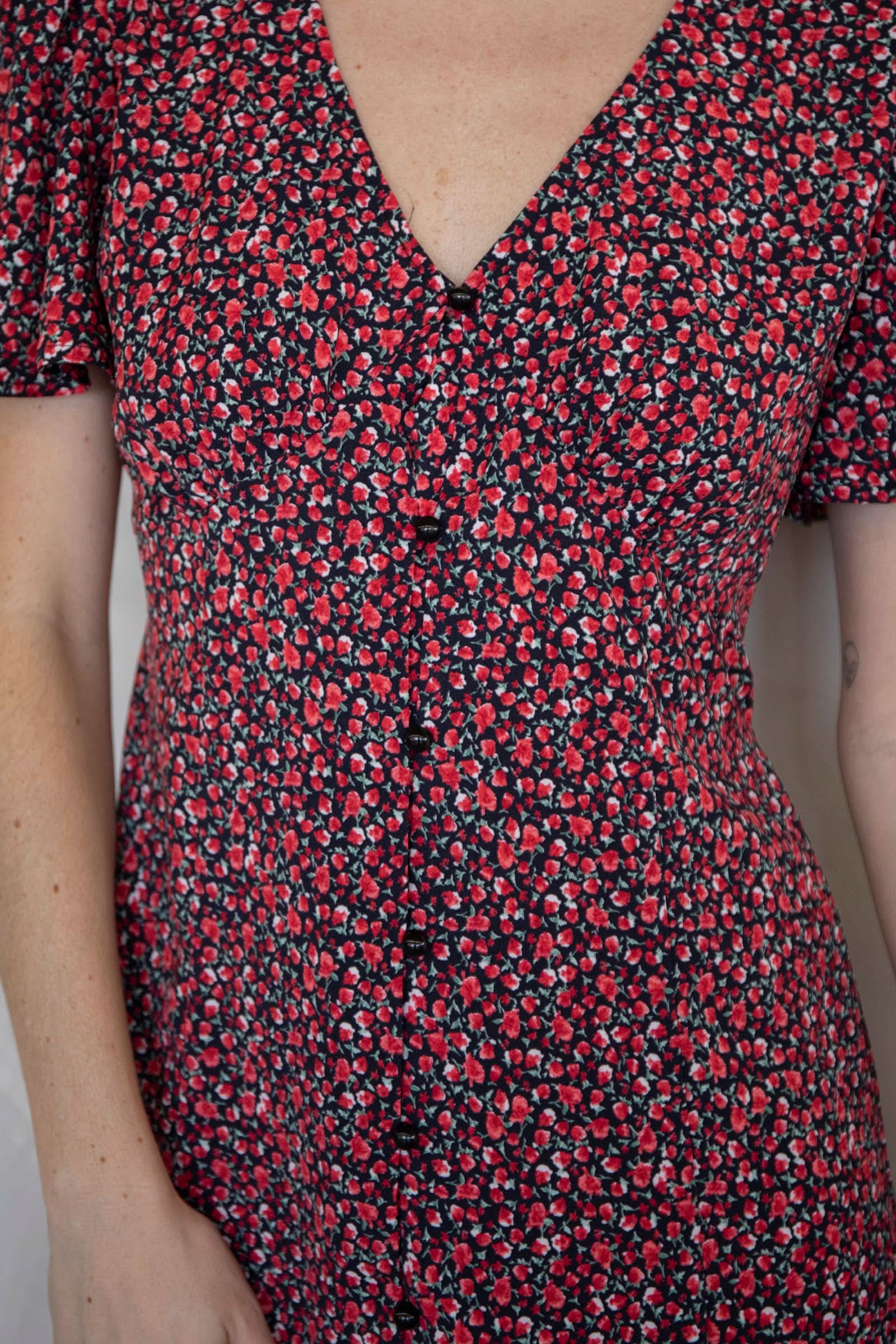 Close-up of a red and black floral dress Ara Mini Dress