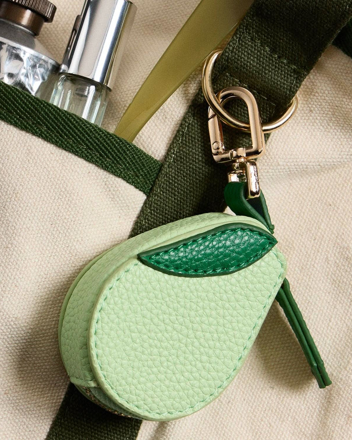 Textured light green avocado-shaped coin purse and a gold-tone