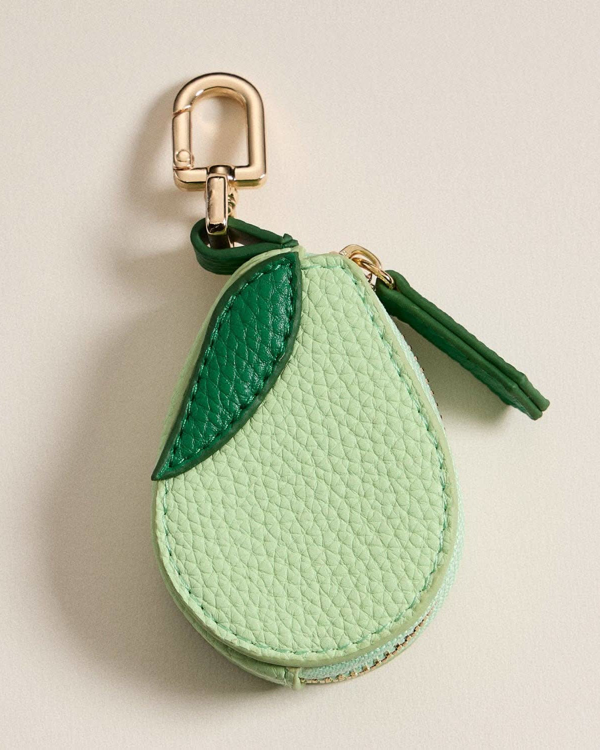 Keychain coin purse shaped like an avocado, with a gold-tone clasp.