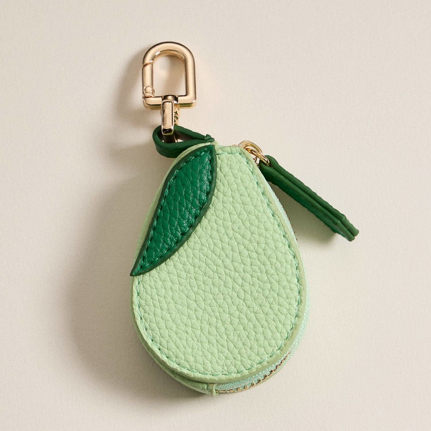 Keychain coin purse shaped like an avocado, with a gold-tone clasp.