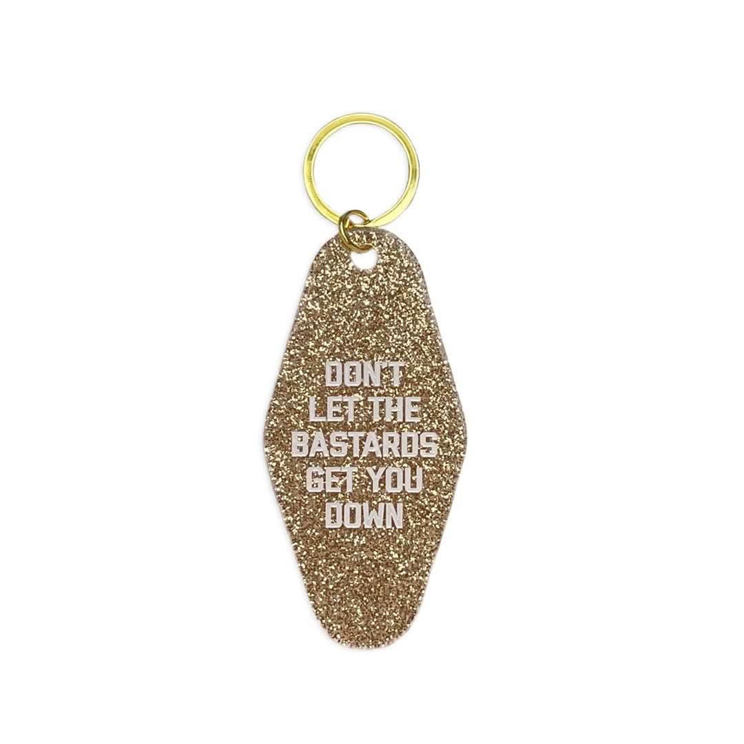 Gold Don’t Let The Bastards Get You Down motel keychain- Form + Content