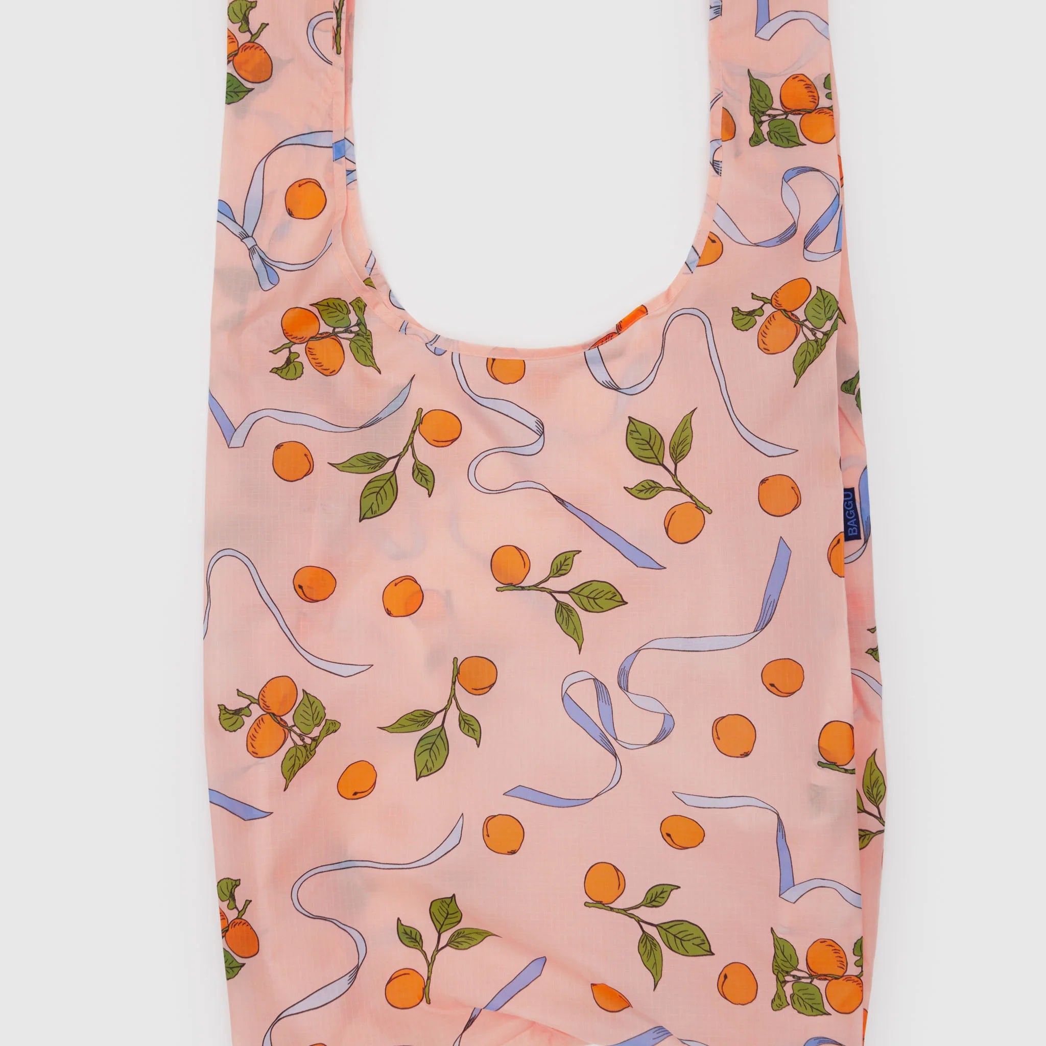Reusable bag with orange and ribbon pattern on a light pink color