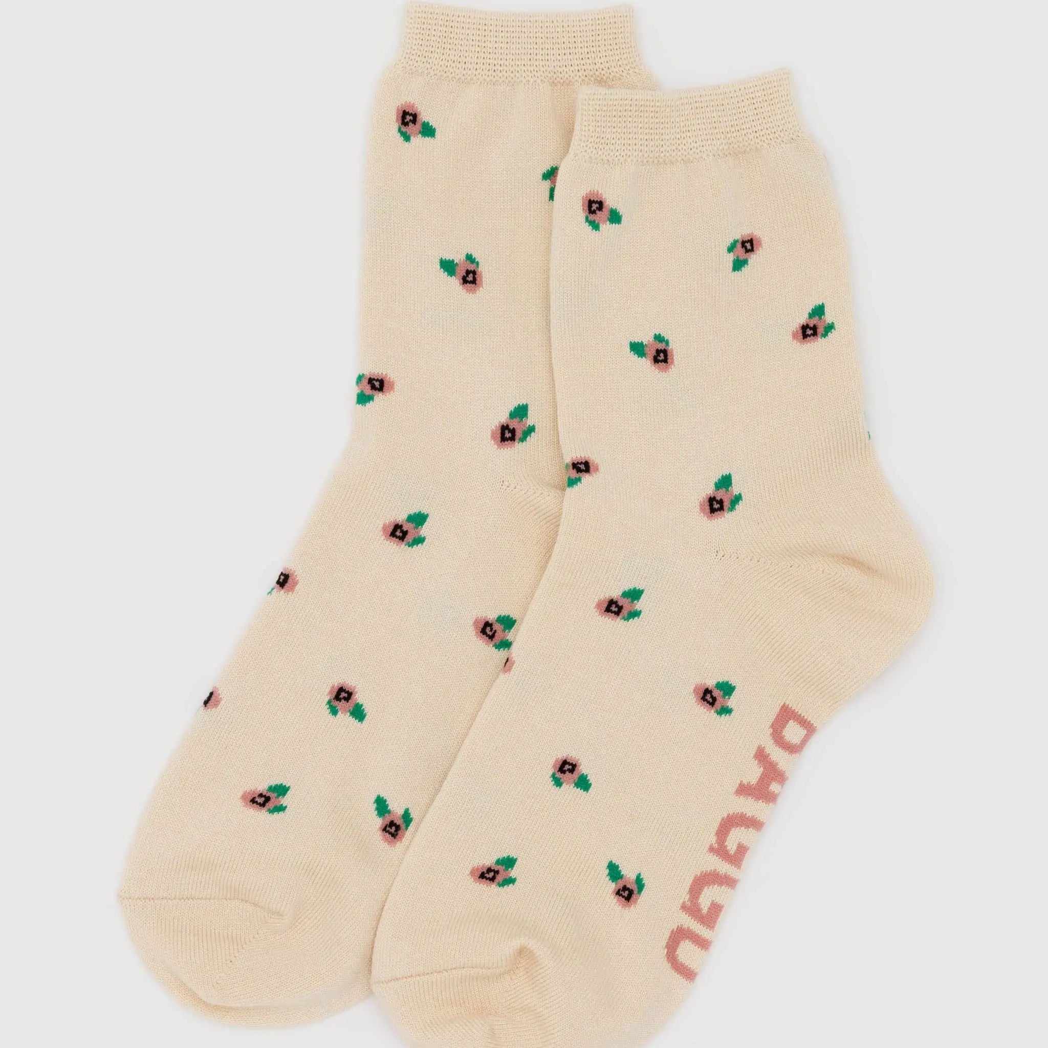 Beige socks with floral patterns and 'Puma' branding on a white background