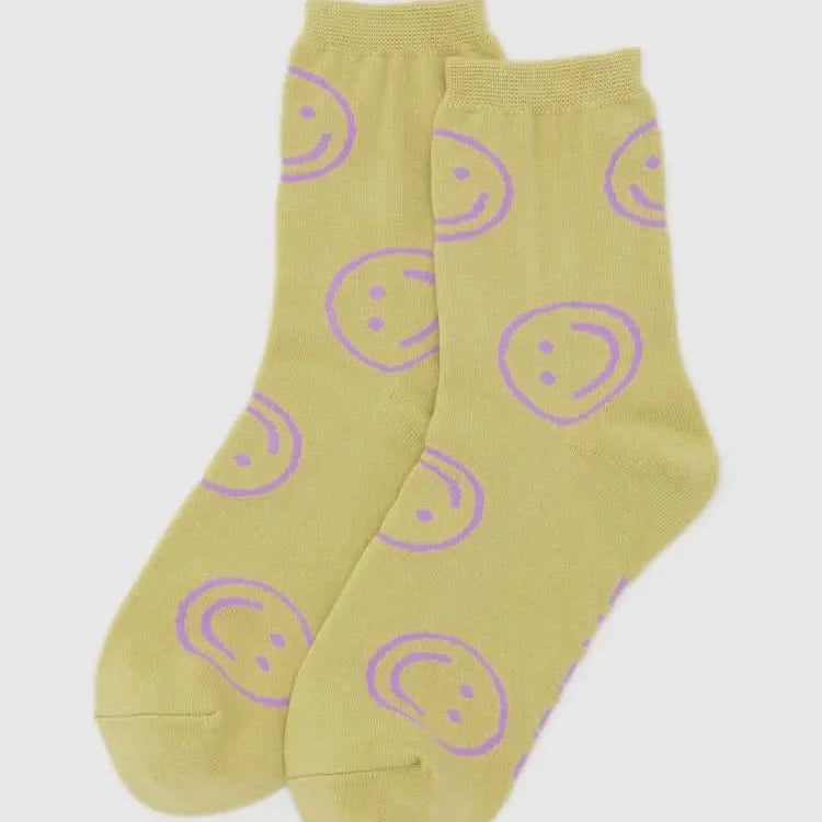 Yellow socks with purple smiley face patterns on a white background