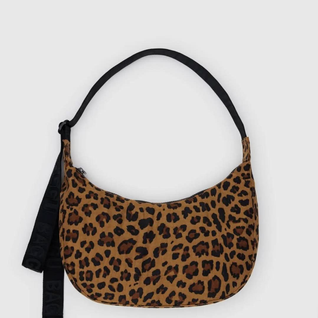 BAGGU leopard print purse with black strap laying flat on a white background