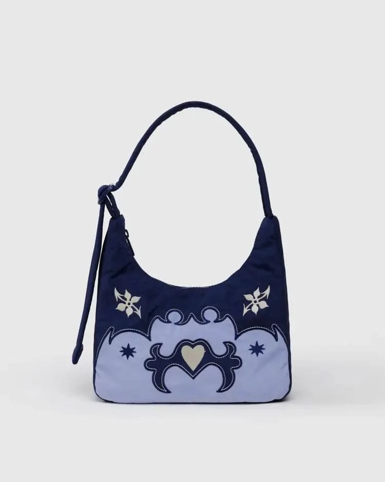 Navy blue handbag with decorative western elements on a light gray background