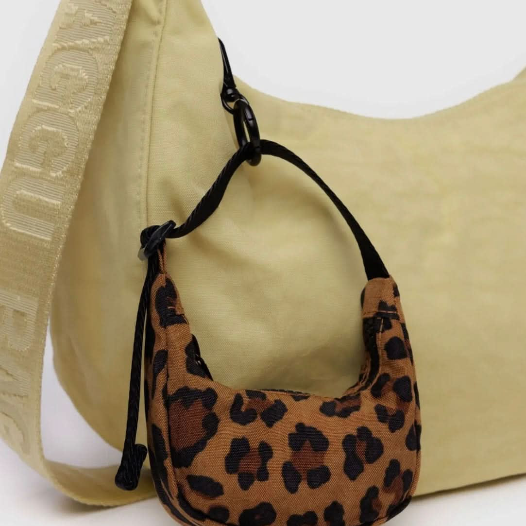 Tiny leopard baby BAGGU bag charm, Fully functional zipper, clipped to a bigger yellow BAGGU bag