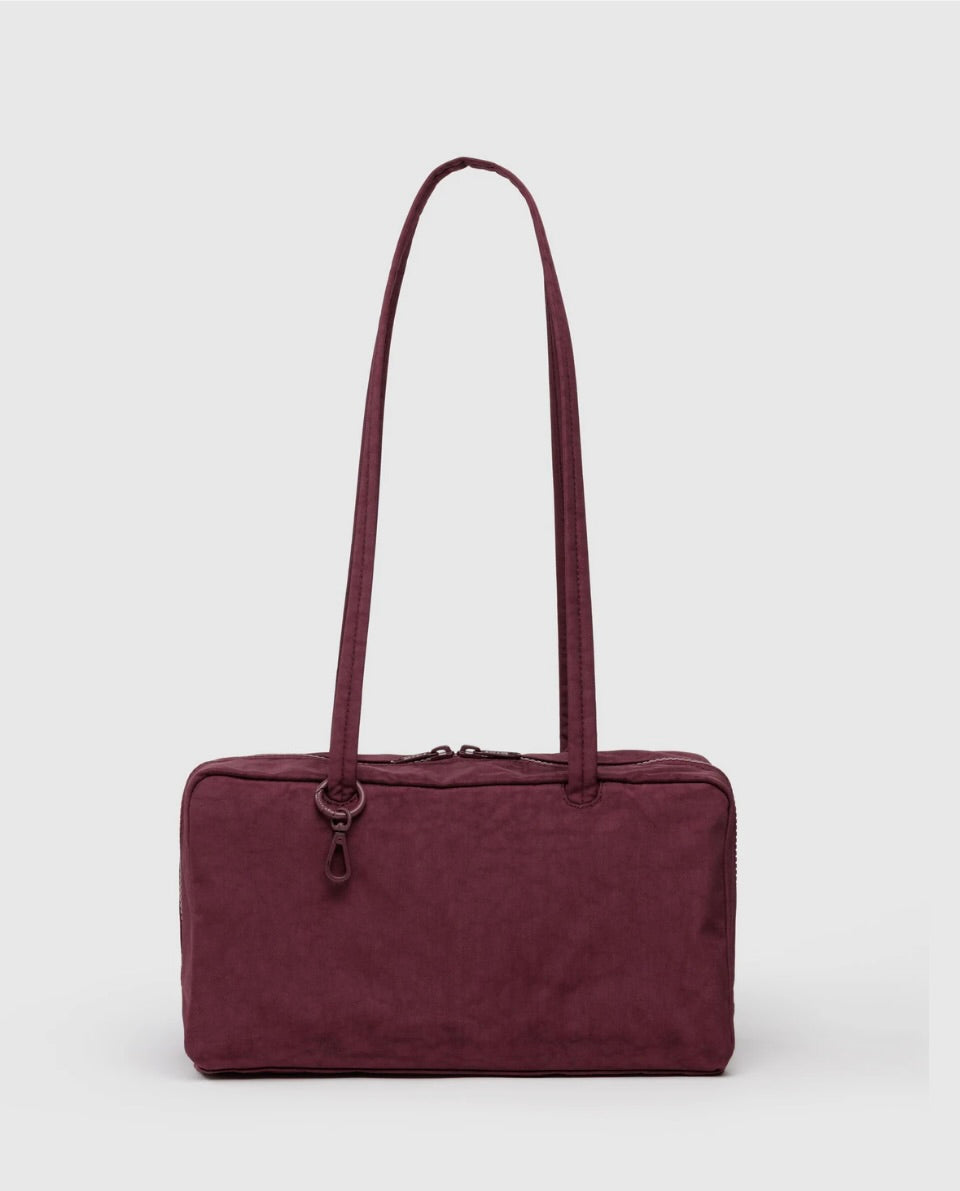 Maroon BAGGU bowler bag with a strap on a white background