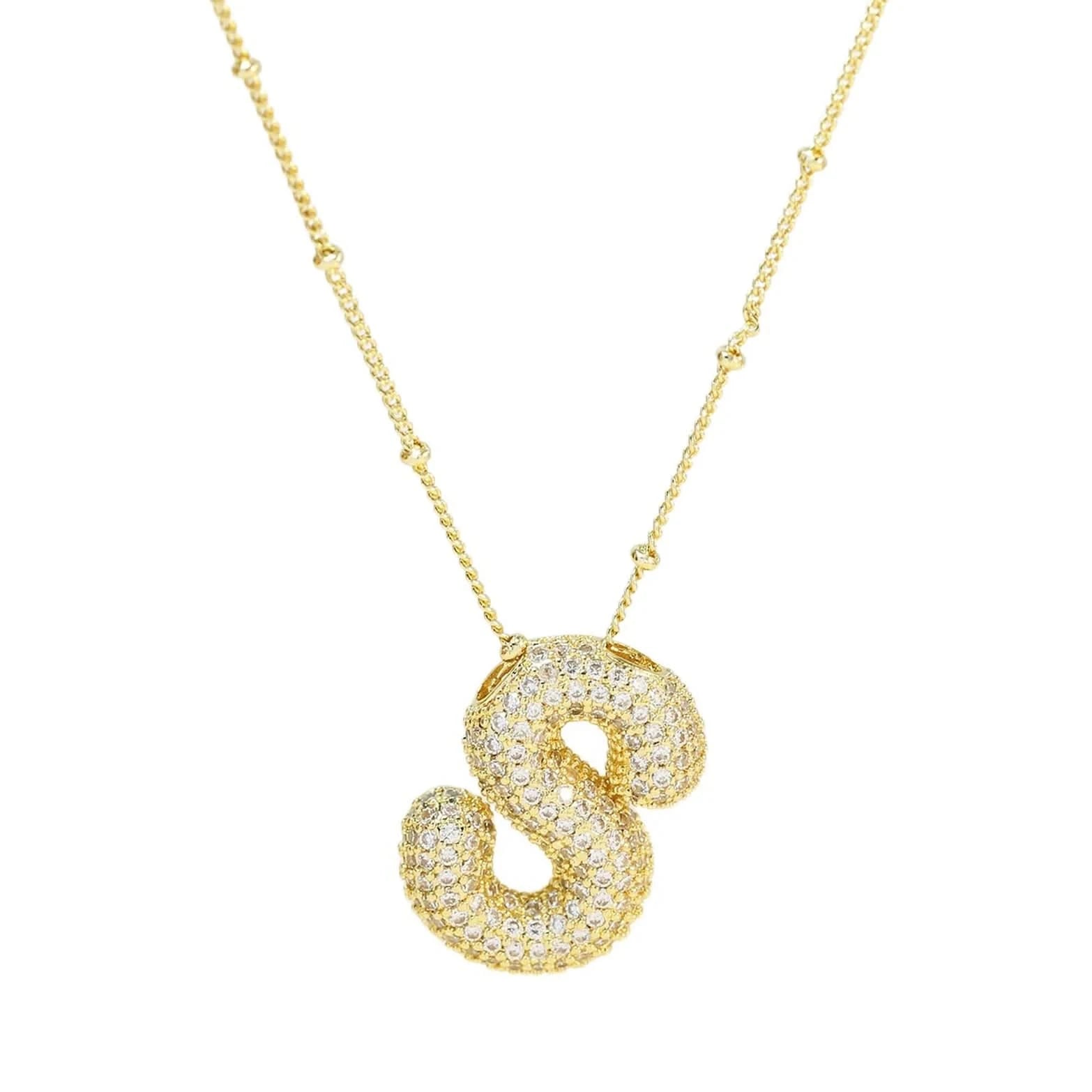 Gold necklace with a letter 'S' pendant on a white background