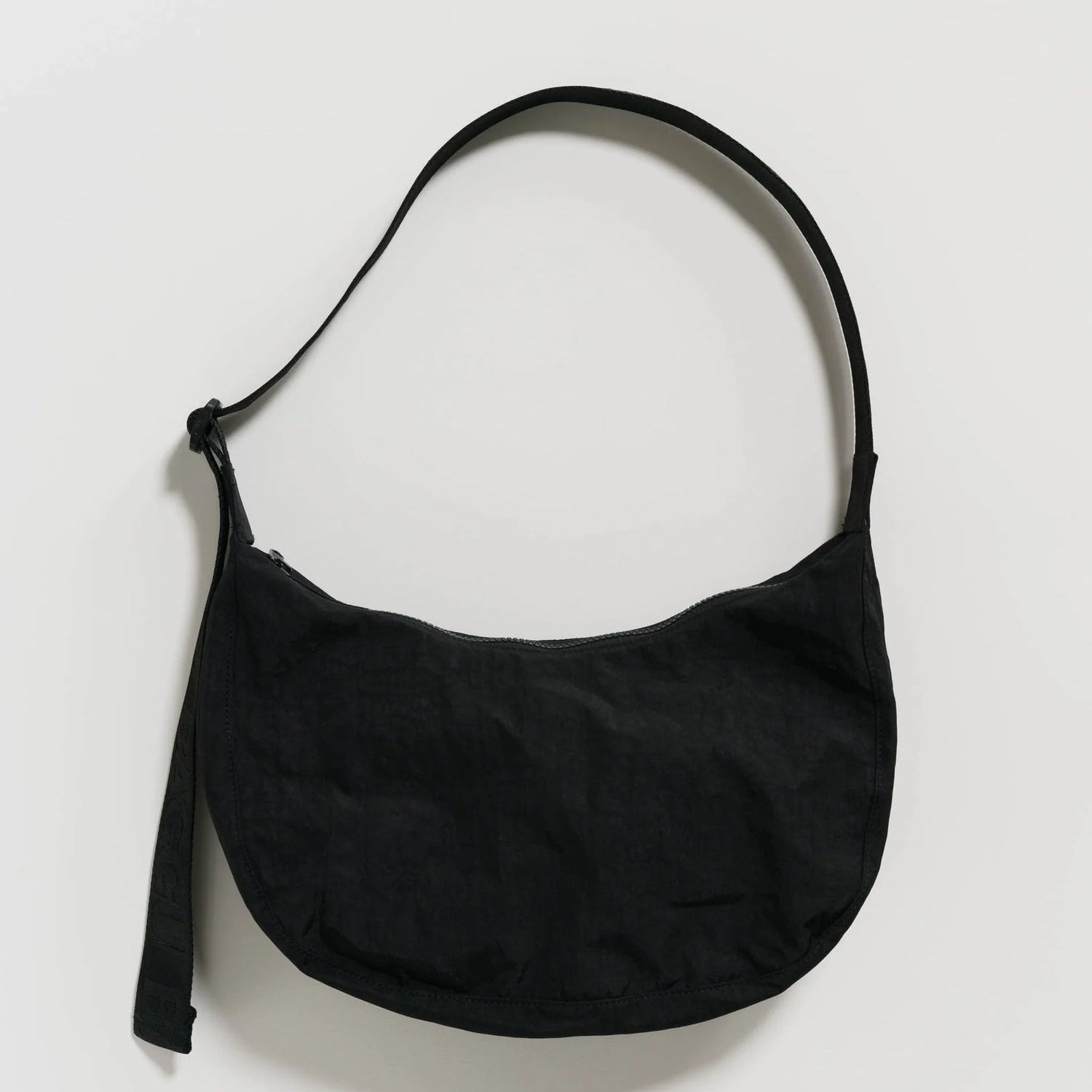 Black shoulder bag on a light gray background