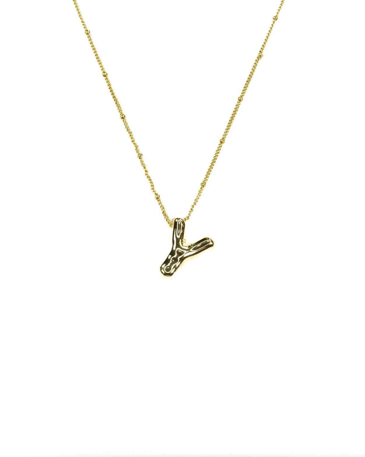 Gold necklace with a small Y pendant on a white background