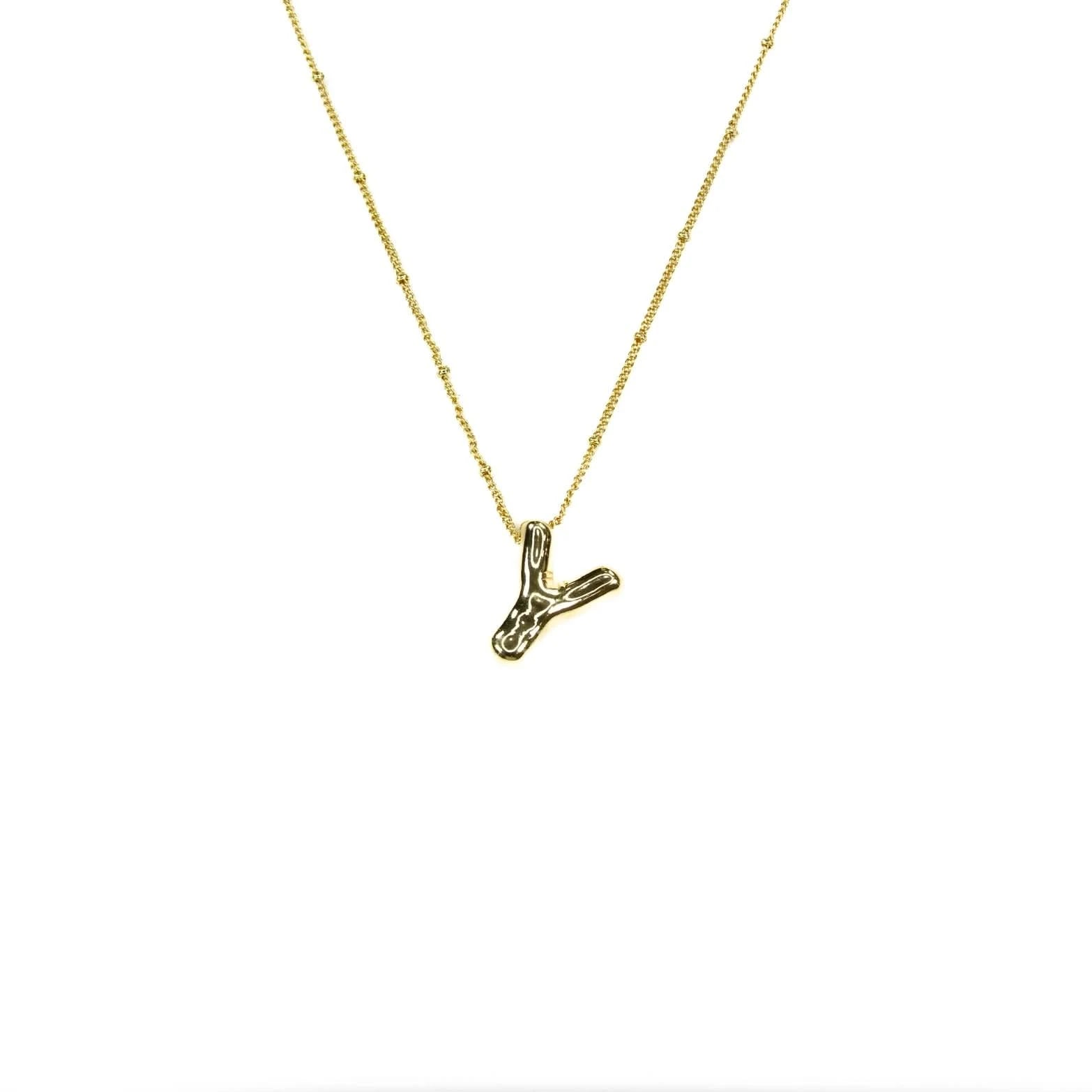 Gold necklace with a small Y pendant on a white background