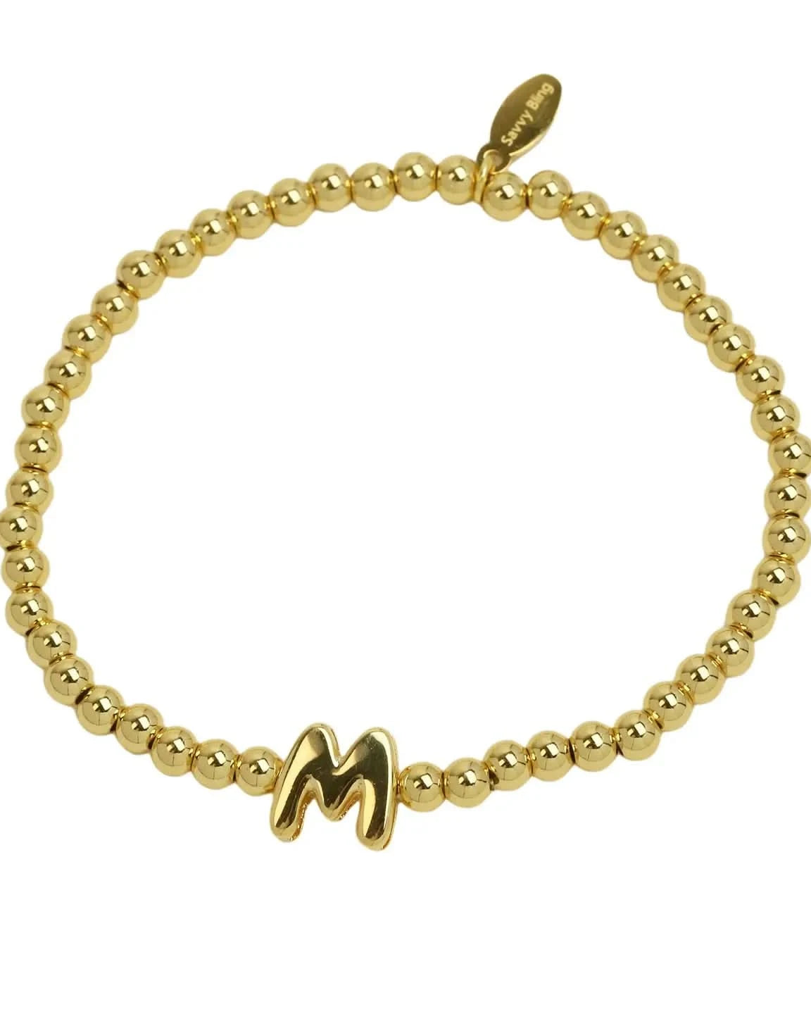 Gold beaded bracelet with a letter 'M' charm on a white background