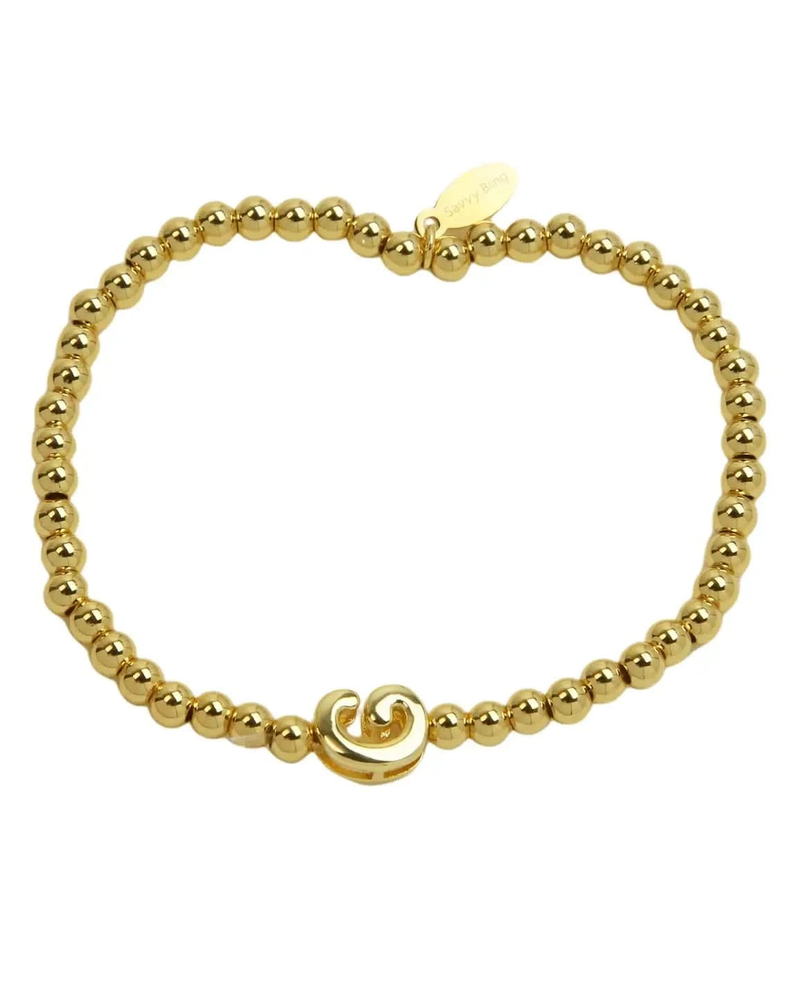 Gold beaded bracelet with a wave charm on a white background