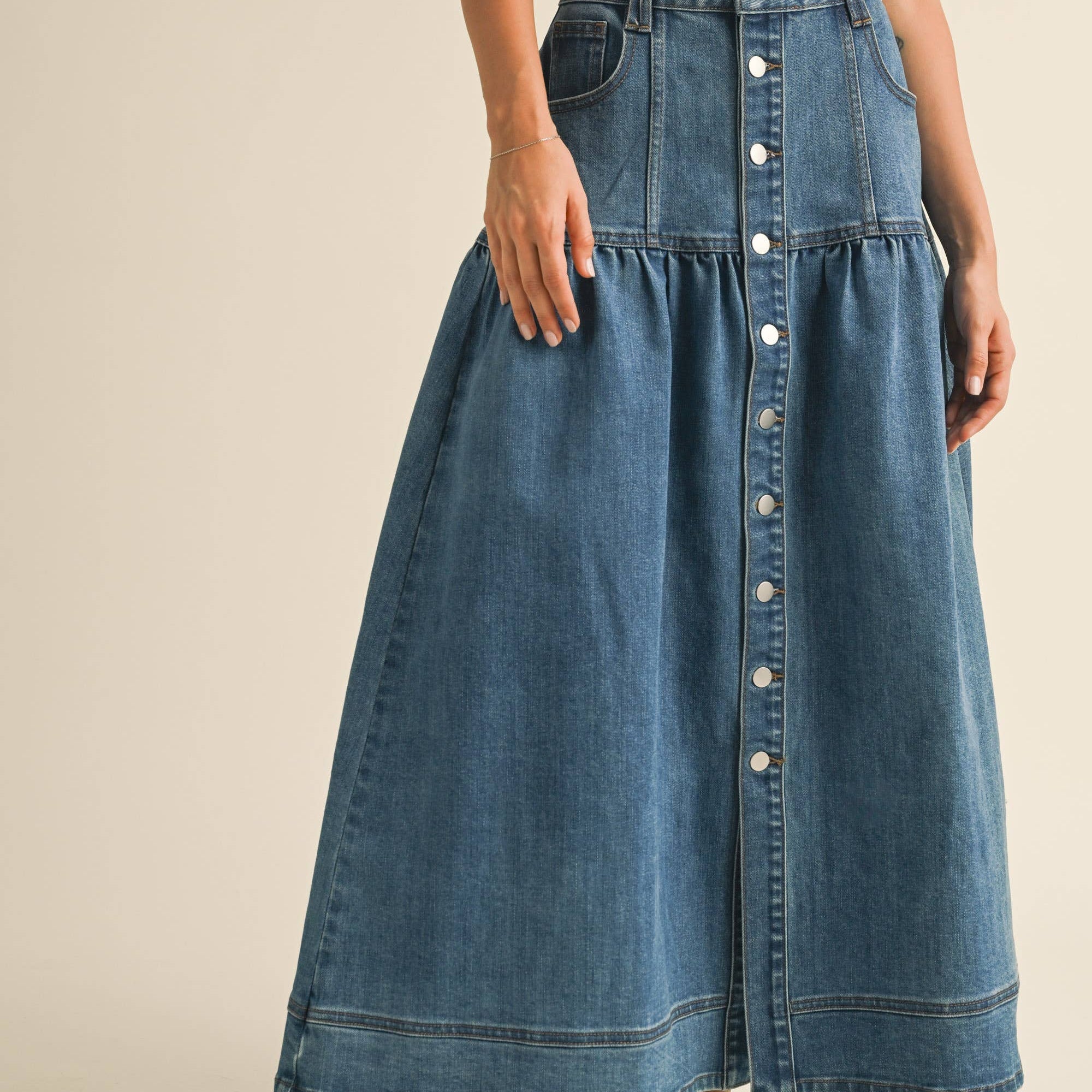 Crafted from classic denim, it features a charming front button closure that adds personality to your everyday rotation