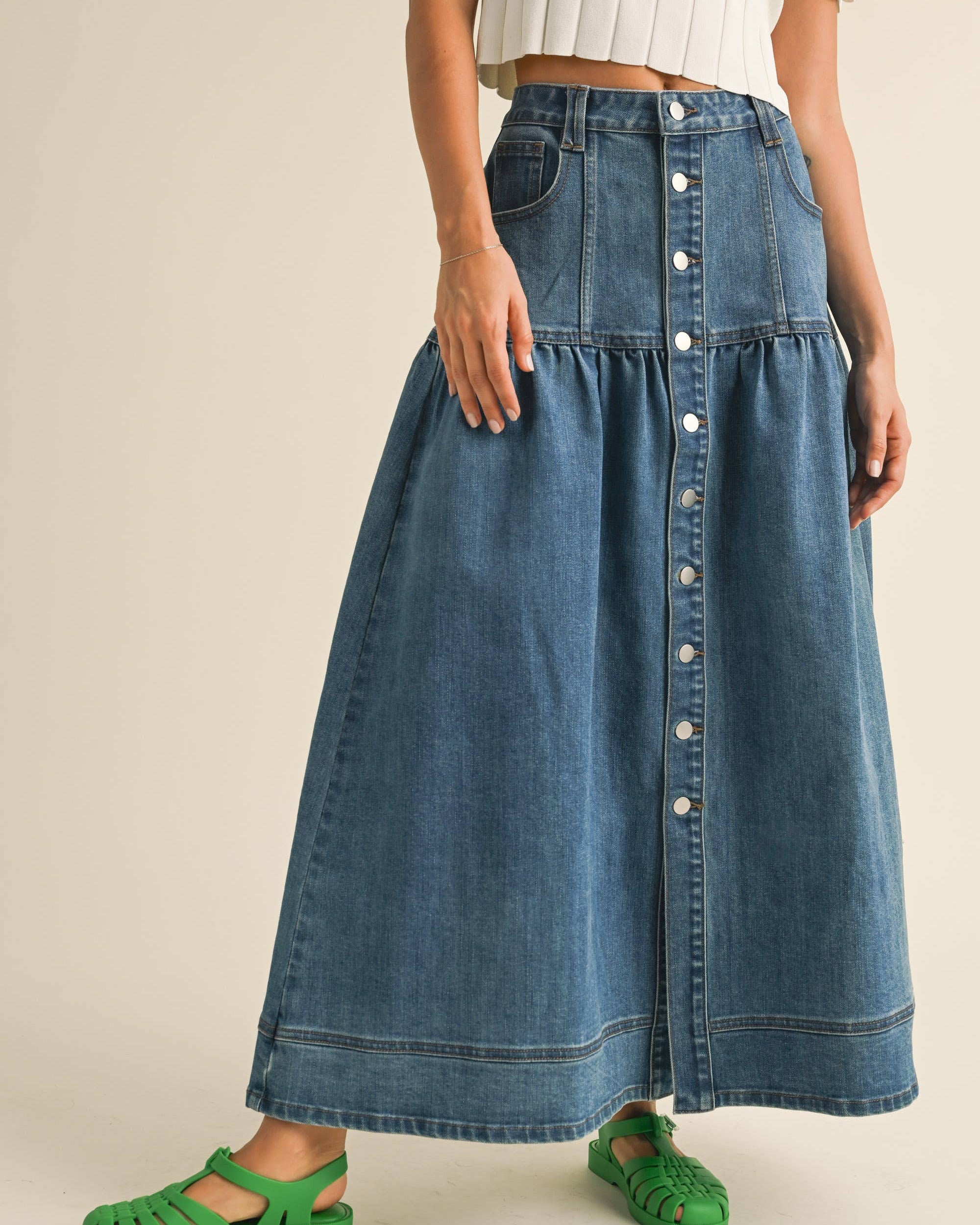 Crafted from classic denim, it features a charming front button closure that adds personality to your everyday rotation