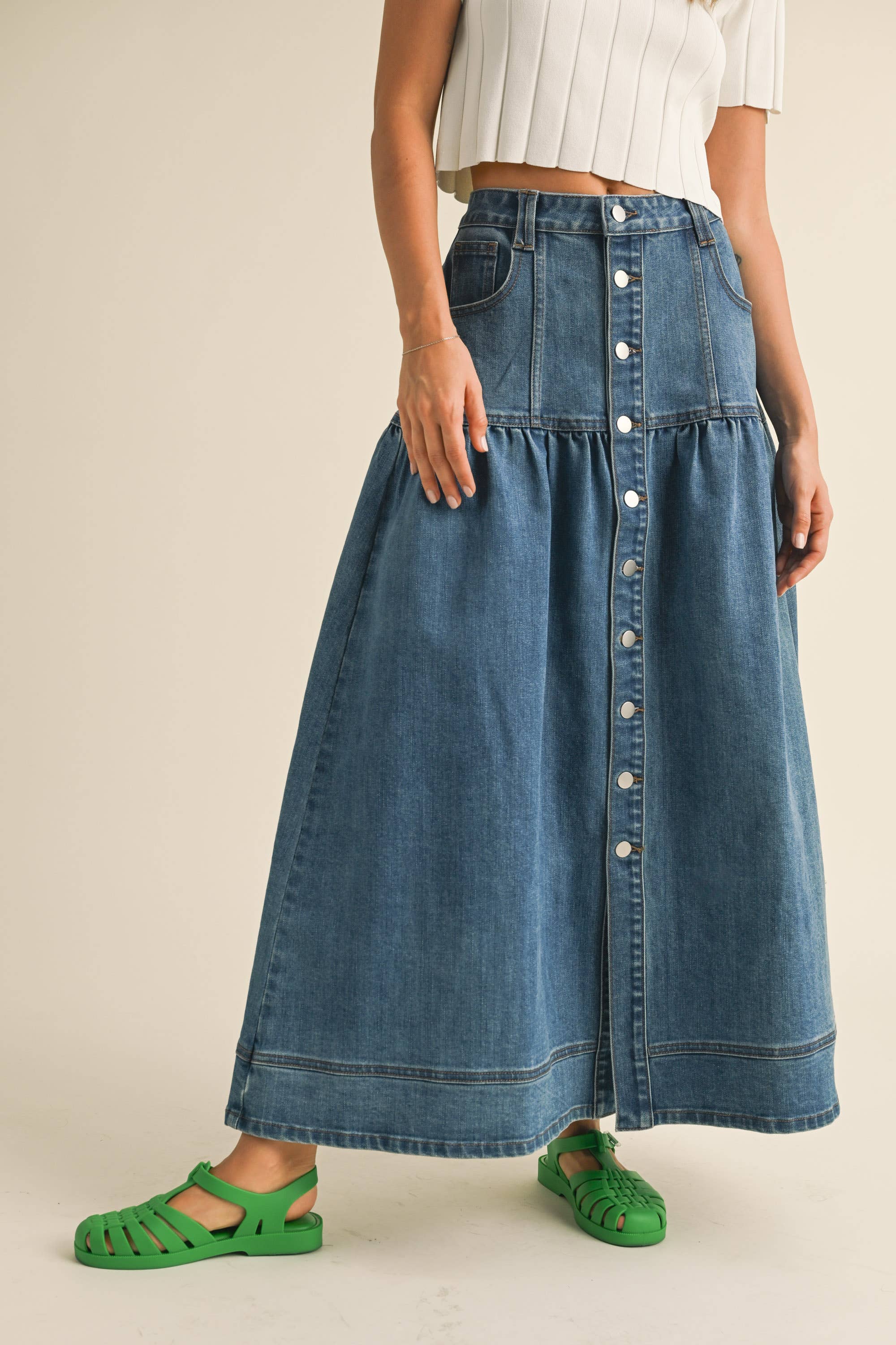 Crafted from classic denim, it features a charming front button closure that adds personality to your everyday rotation