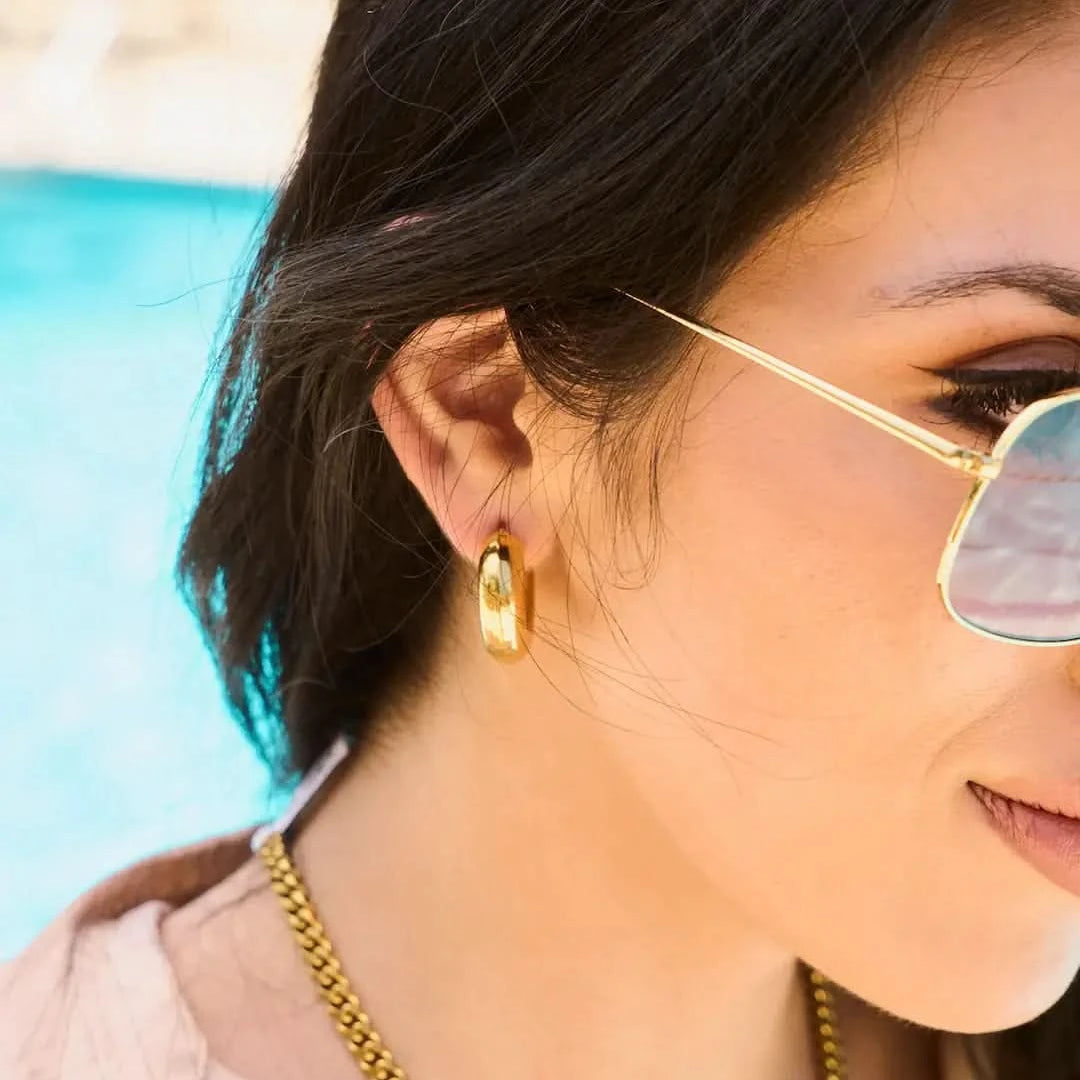 Woman wearing Chunky thick tube hoop earrings
