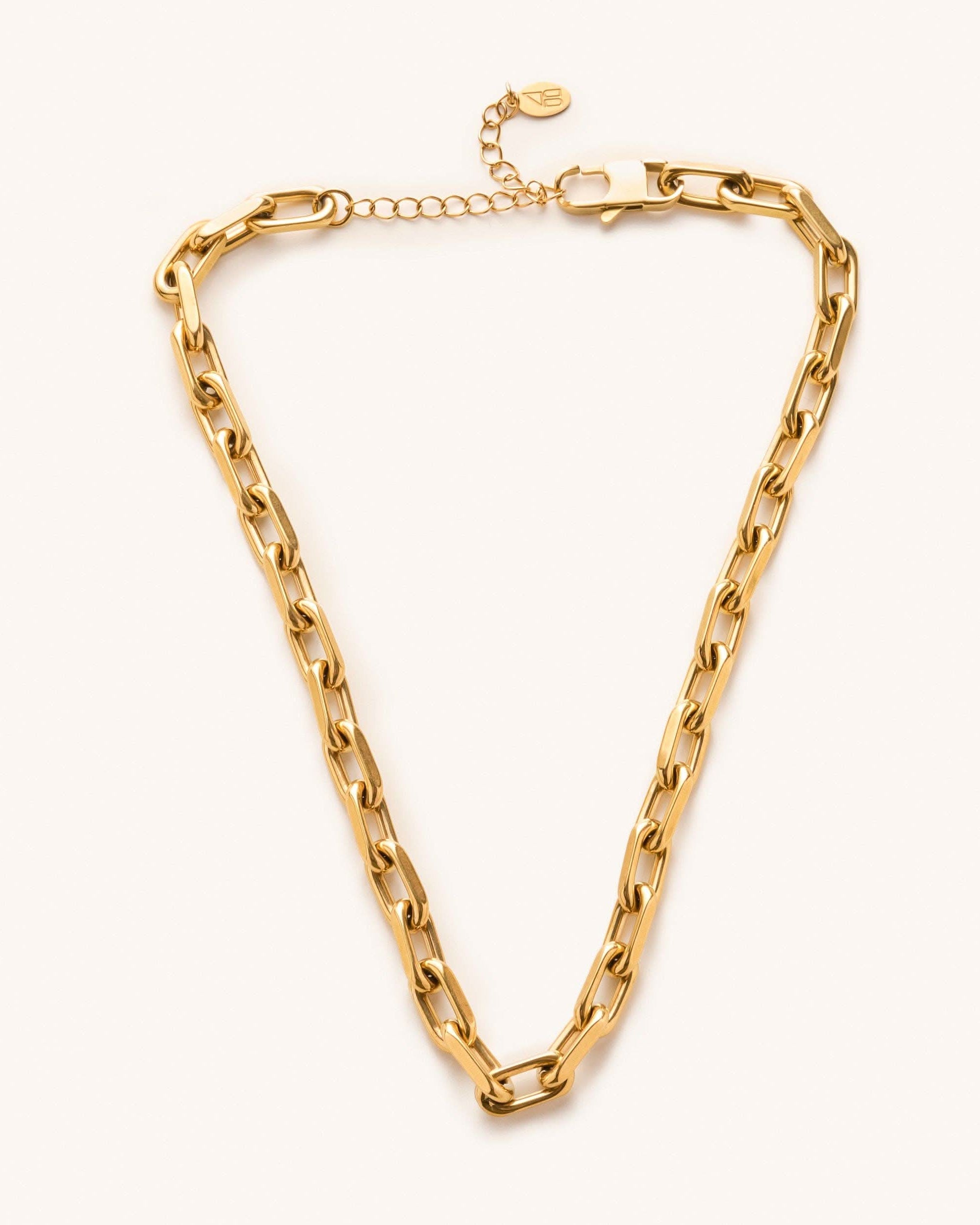 a gold, waterproof, chunky link choker necklace laying on a white background