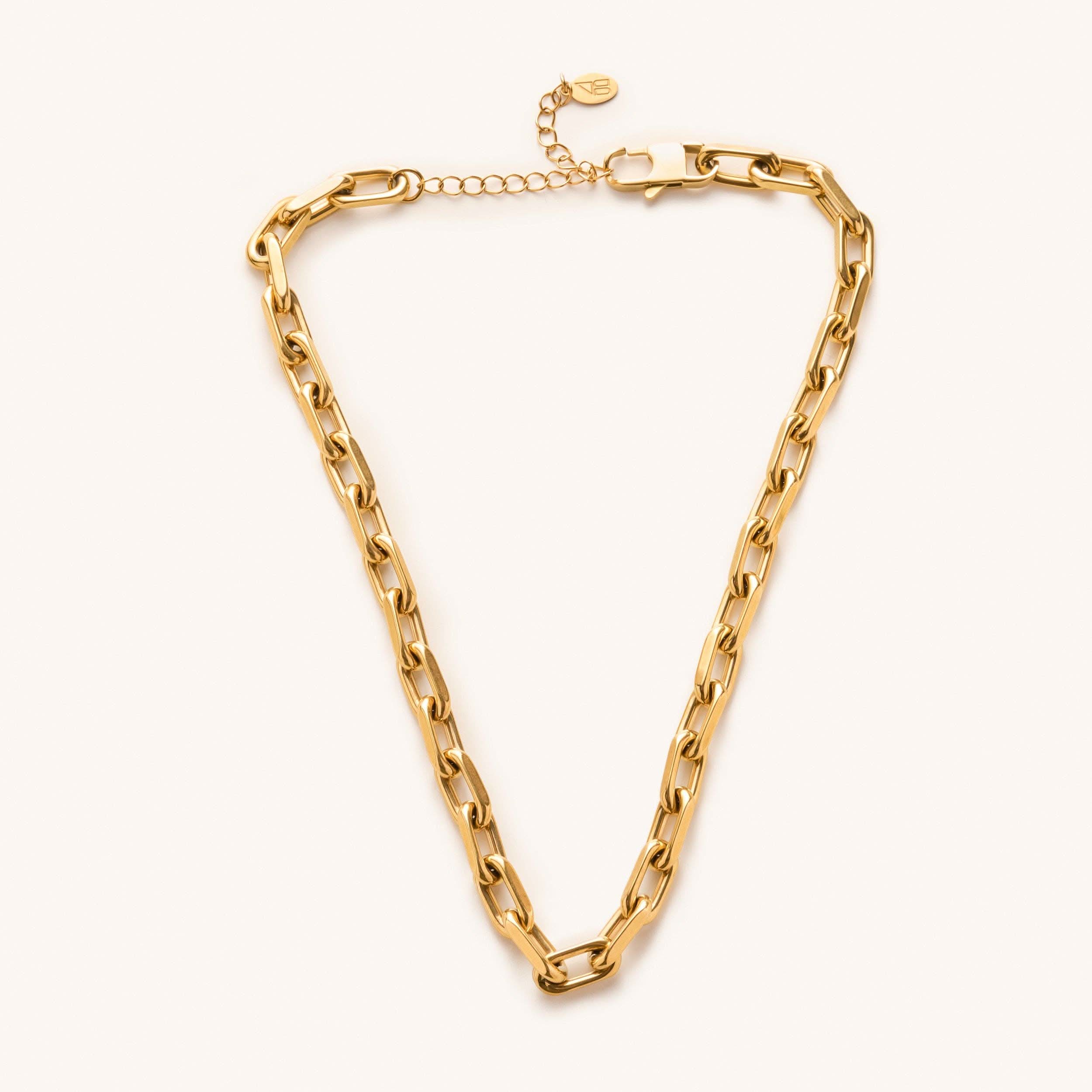 a gold, waterproof, chunky link choker necklace laying on a white background