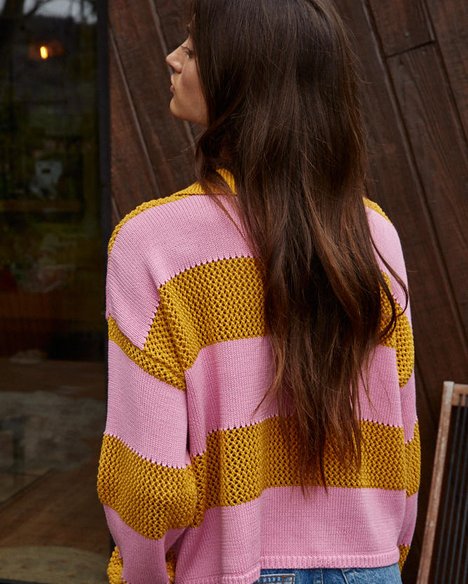 Woman wearing a pink and yellow striped sweater