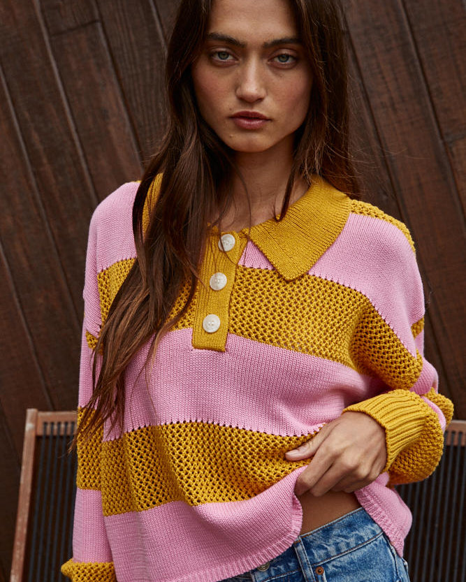 Woman wearing a pink and yellow striped sweater