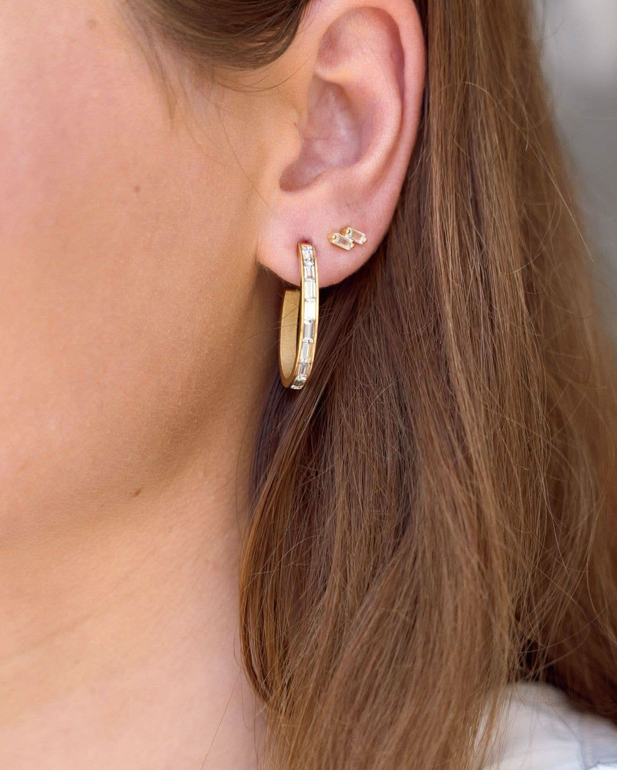 Woman wearing Pair of double Crystal gold micro stud earrings and hoops