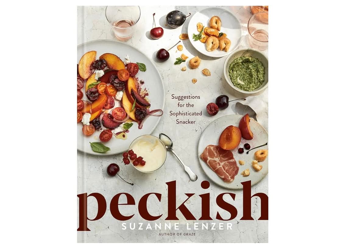 Front cover of a cook book with the title “peckish” by Suzanne Lenzer and various snack dishes on a table