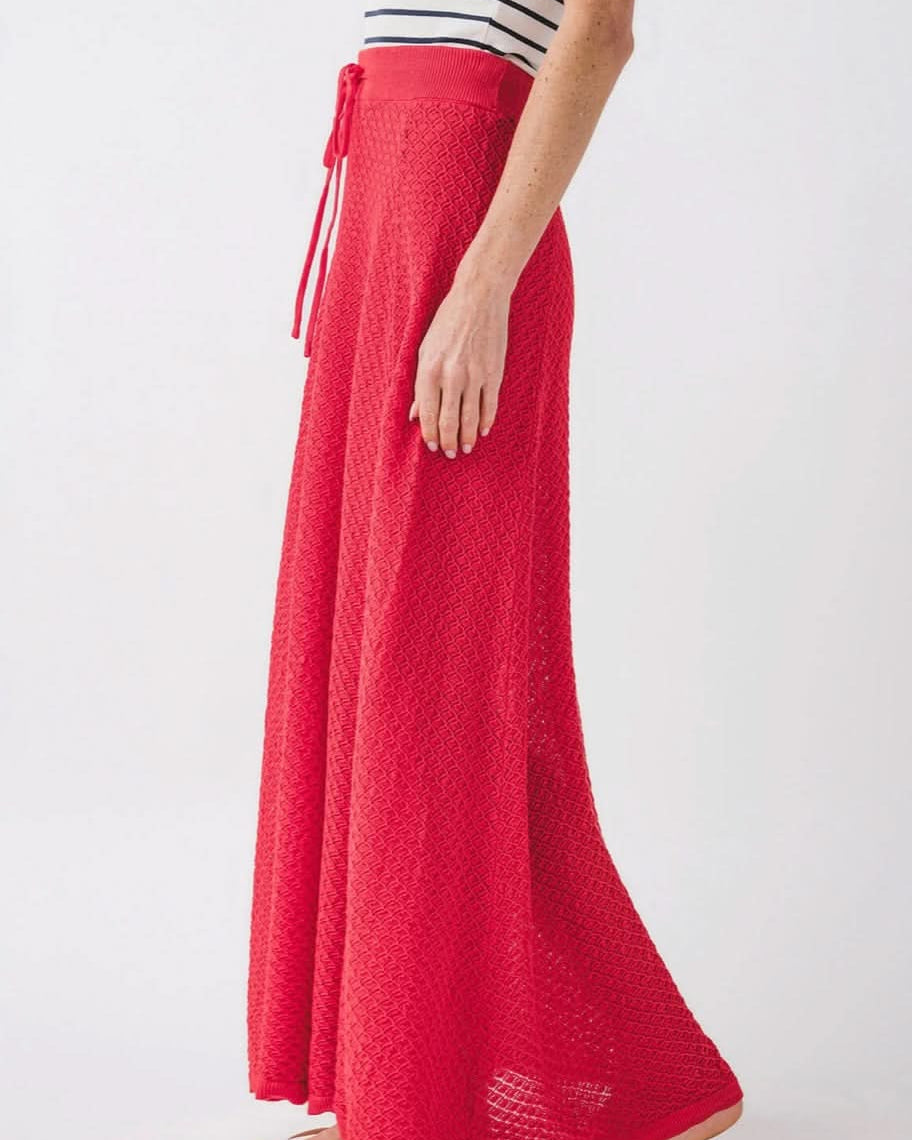 Woman wearing knit red skirt with diamond geometrical pattern and front tie