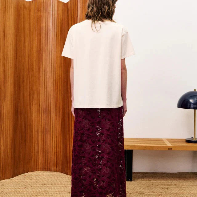 Person wearing burgundy lace skirt Back Side Standing in a room