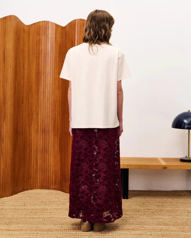 Person wearing burgundy lace skirt Back Side Standing in a room