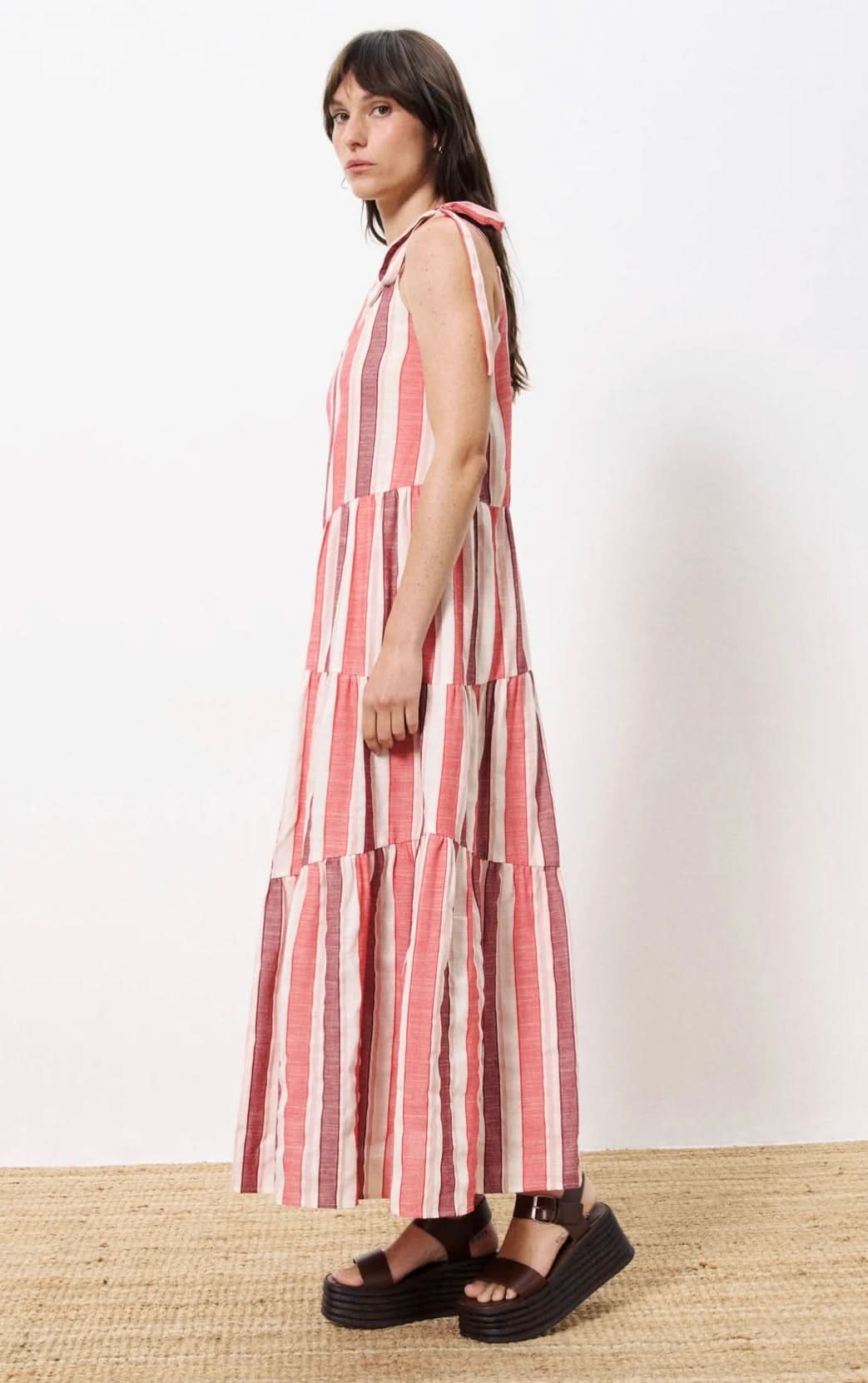 Woman wearing red striped maxi dress with thick should ties with platform sandals