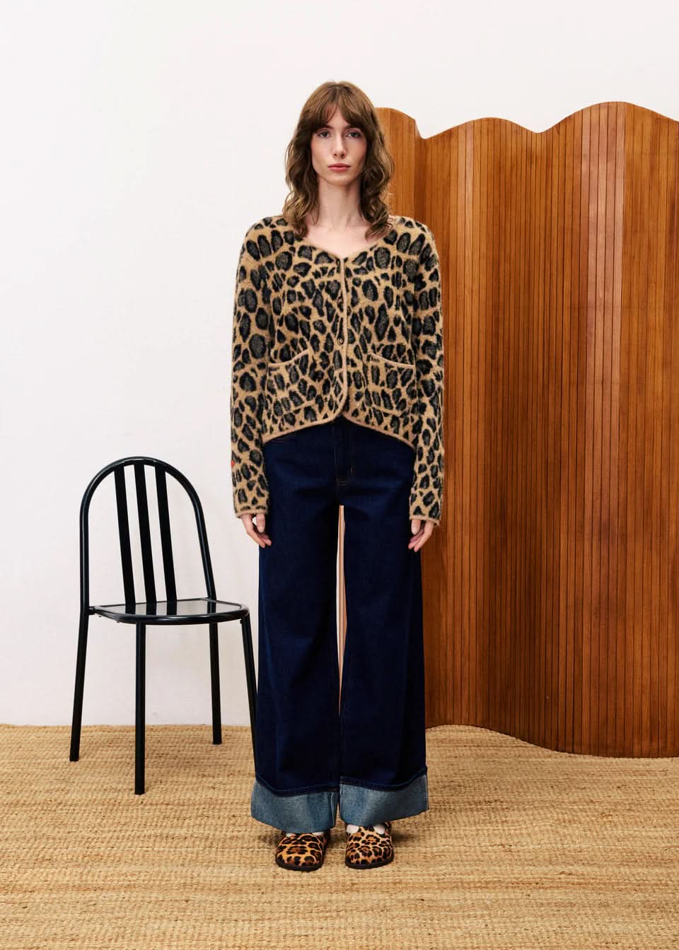 Person wearing a leopard print tFRNCH Leopard Begonia Cardigan