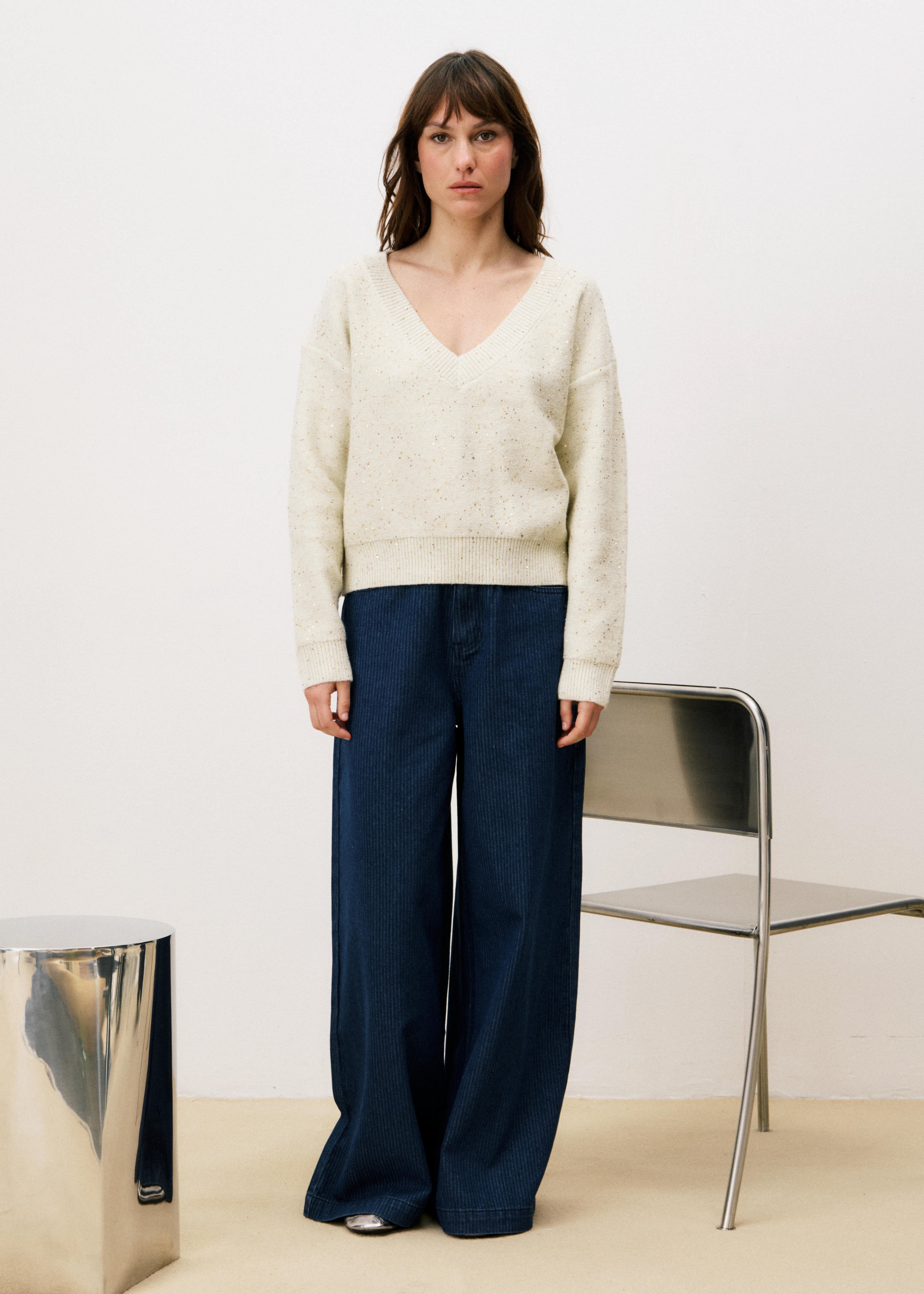 Woman wearing a cream FRNCH Ornella Cream Sweater!