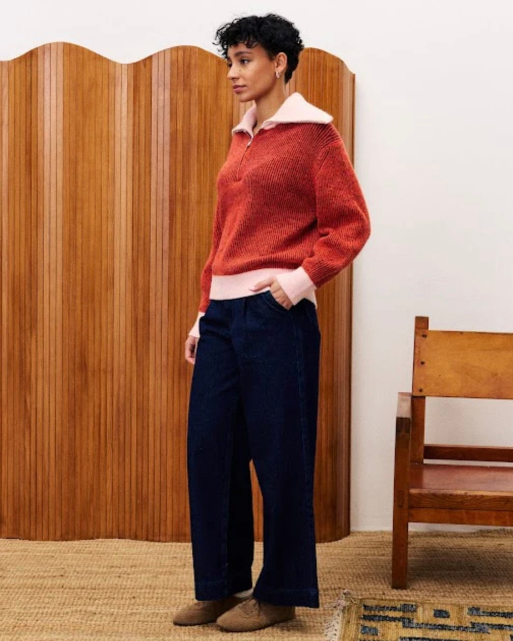 Women wearing a red sweater with Peter Pan or Polo-style collar