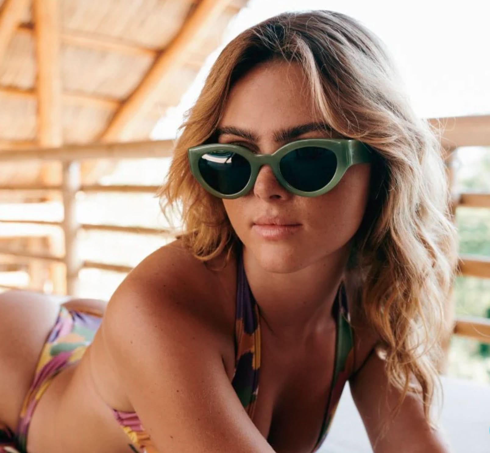 Model wearing moss green sunglasses polarized lens