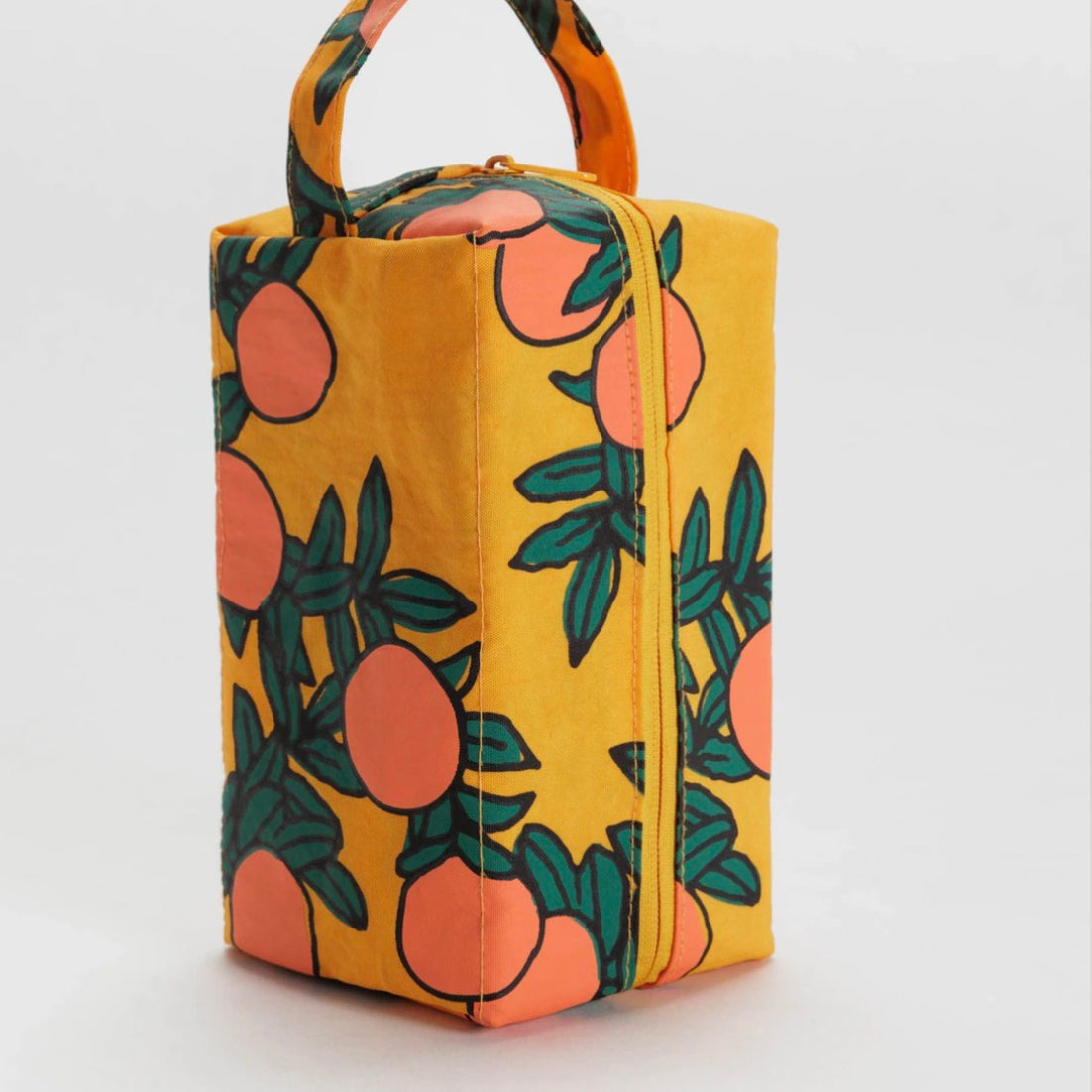 Yellow rectangular bag with orange and green fruit pattern on a white background