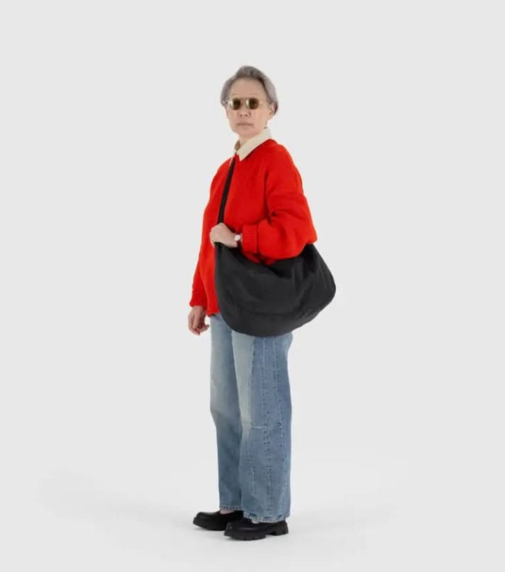 Woman wearing large black purse crossbody