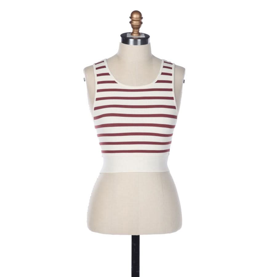 A crème and red striped sleeveless U-V neckline tank top in front of a blank background.