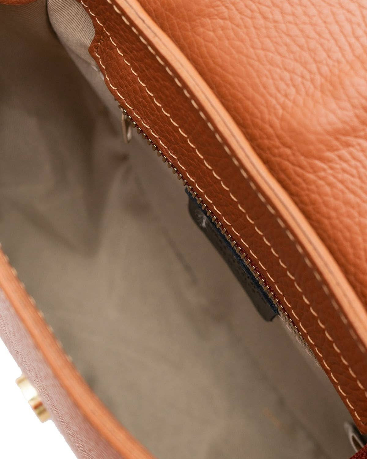 Chestnut brown colored leather crossbody bag with magnetic front clap and leather woven geometric design and gold Metal details