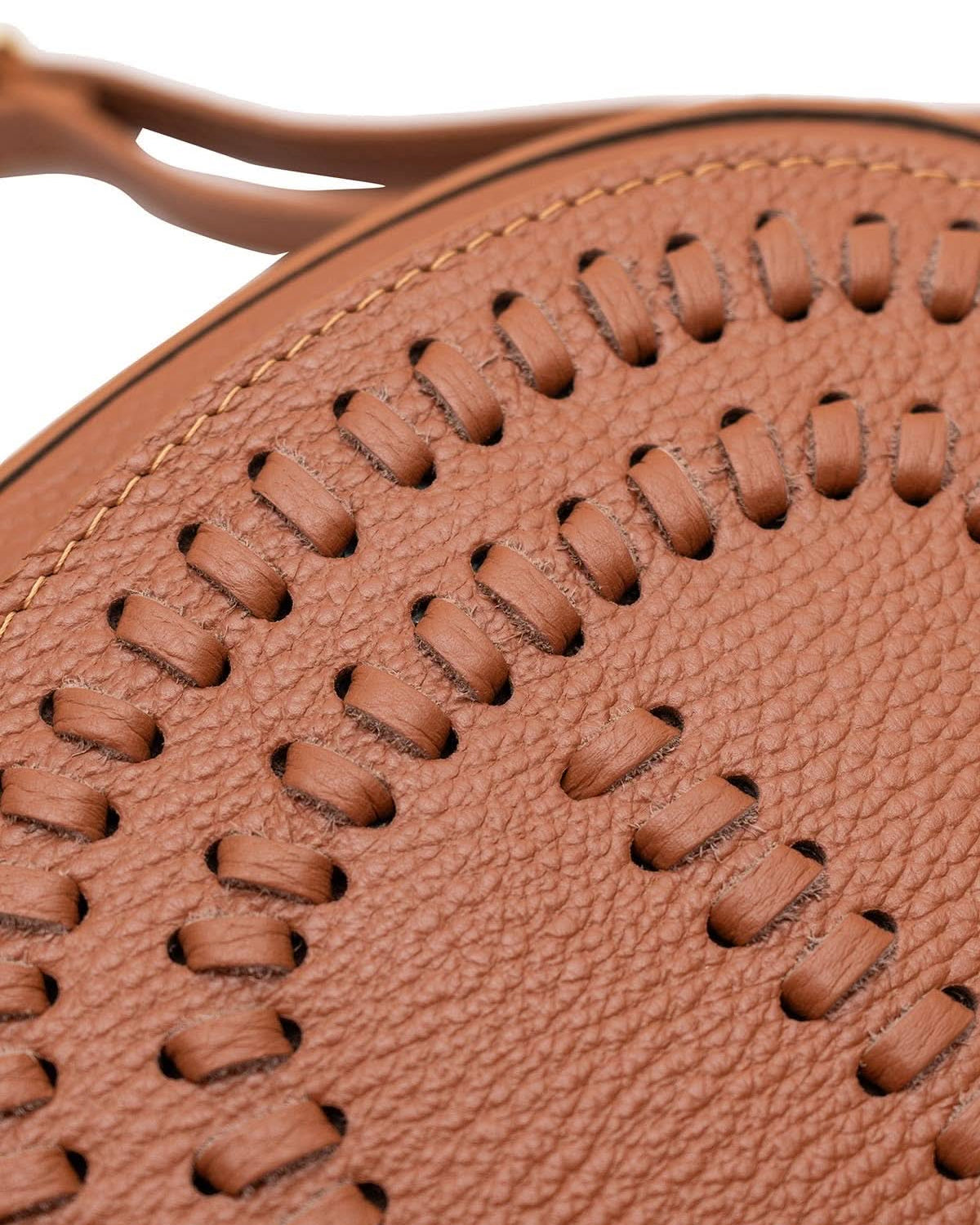 Woven details of Chestnut brown colored leather crossbody bag with magnetic front clap and leather woven geometric design and gold Metal details