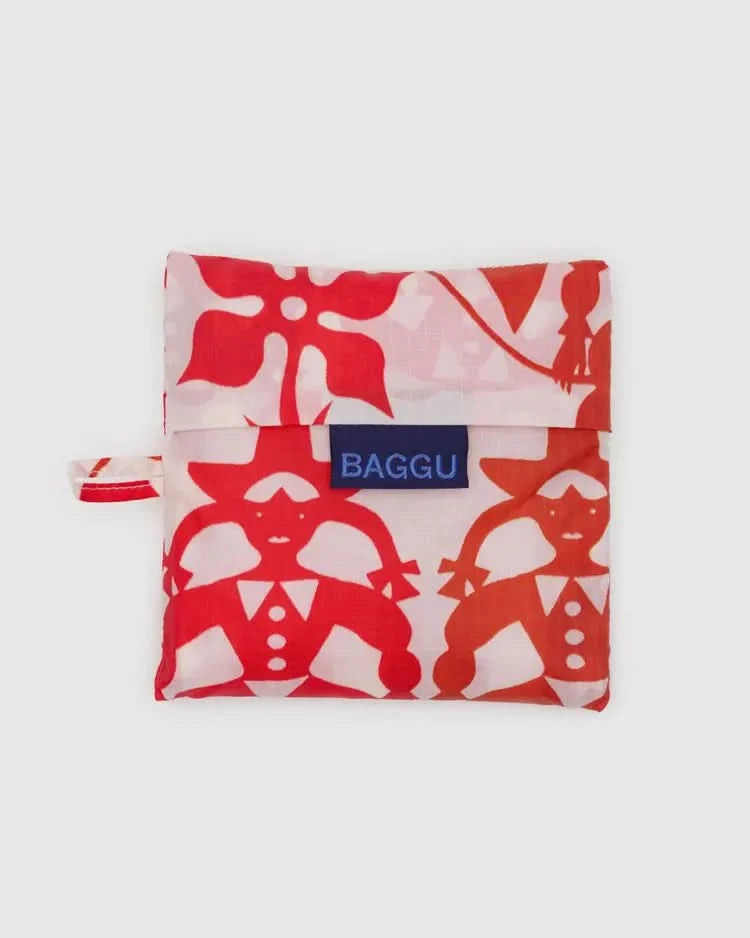 Folded up Pinkish white baby baggu reuseable grocery bag with red cowgirl print throughout the bag