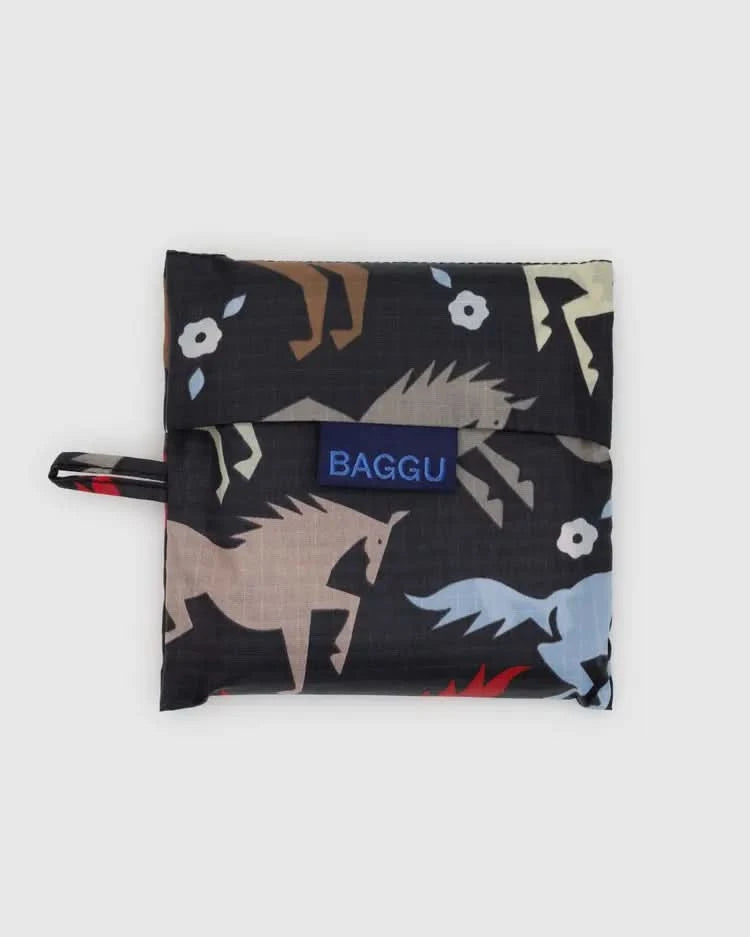 Folded up Dark grey black baby baggu reuseable bag with colorful horse cutouts throughout the print