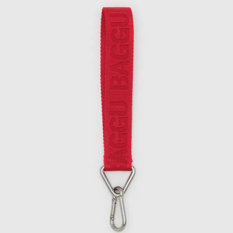 Red strap with a metal clip on a white background