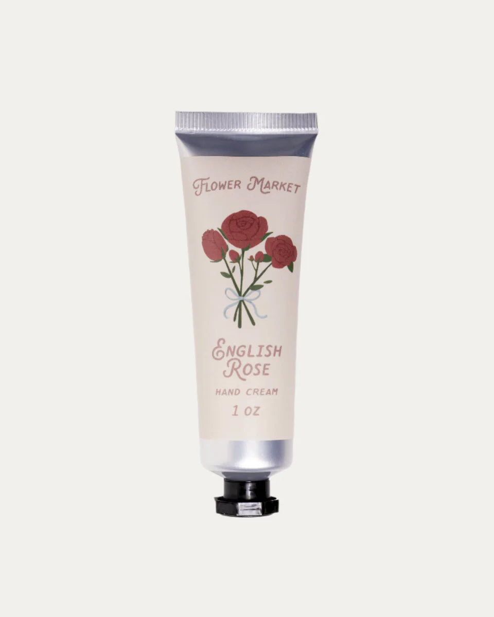 Hand cream tube labeled 'English Rose' with floral design on a light gray background