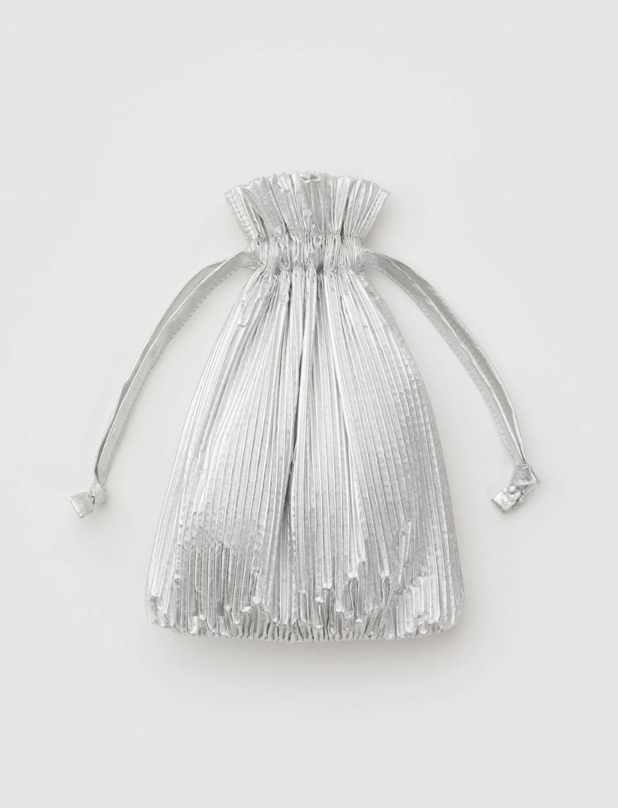 Silver pleated drawstring bag on a light gray background