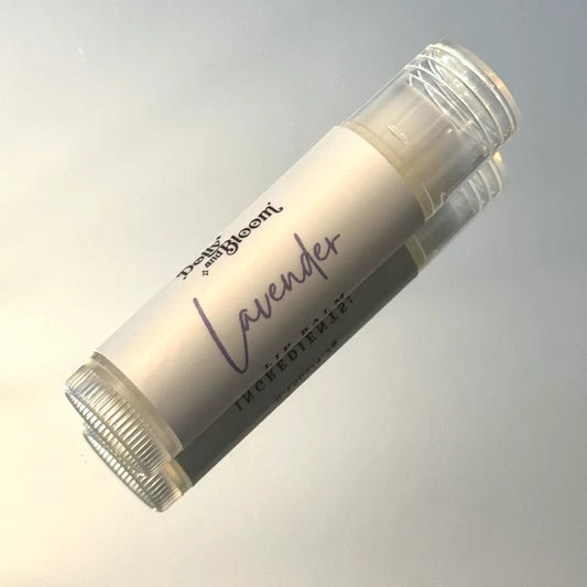 Lip balm stick labeled 'Lavender' on a gradient gray background