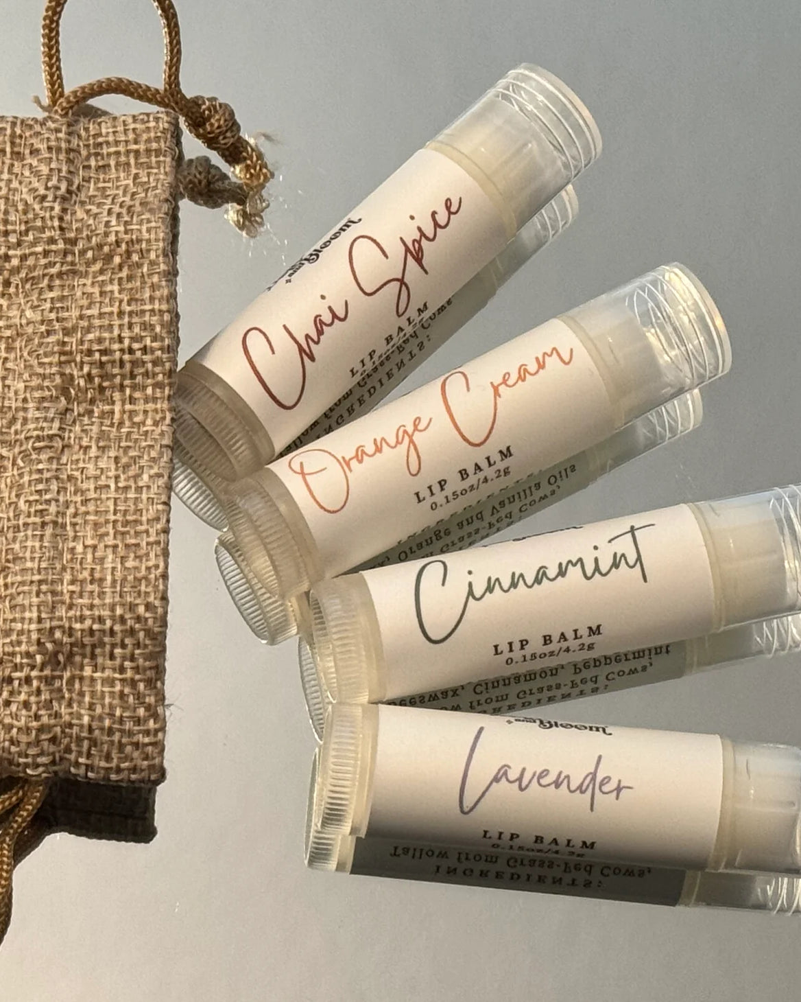 Set of lip balms with visible labels on a gray background